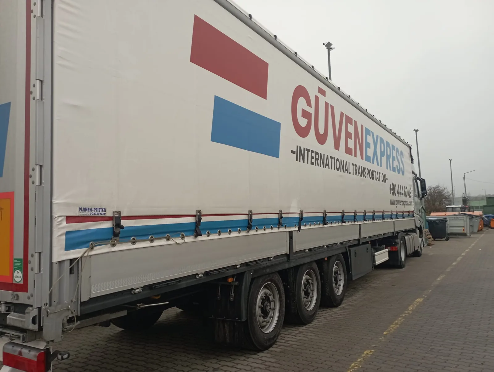 GüvenExpress branded trailer at a logistics facility