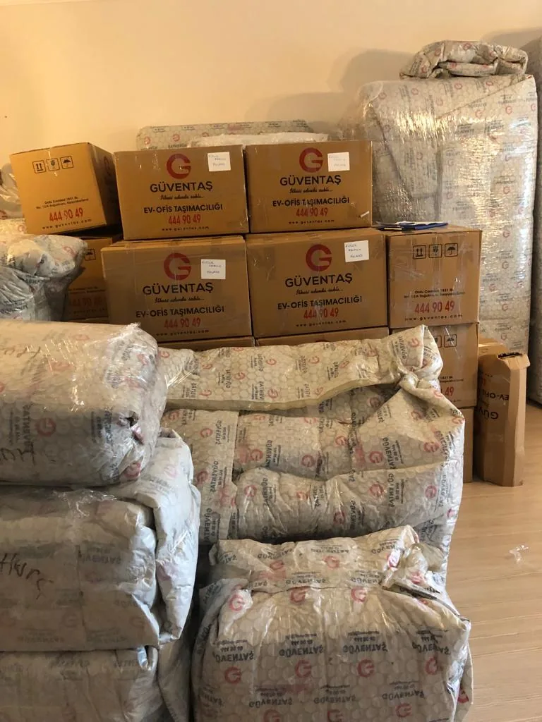 Labeled GüvenExpress boxes and protected goods ready for loading